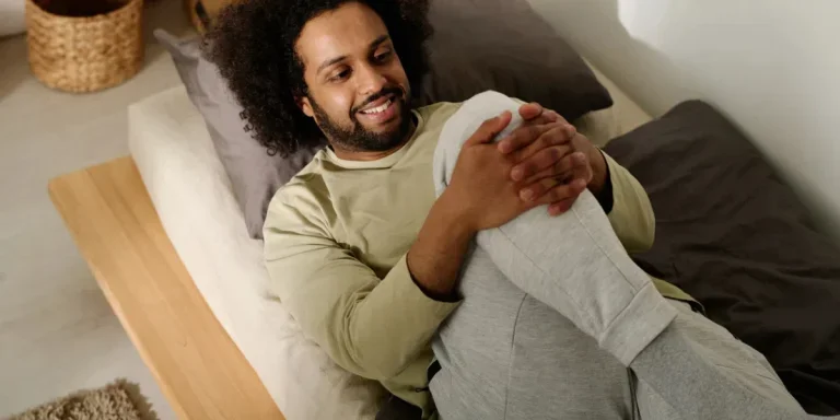 Smiling man doing stretching exercise