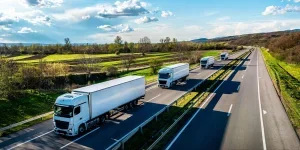 white trucks with containers on highway