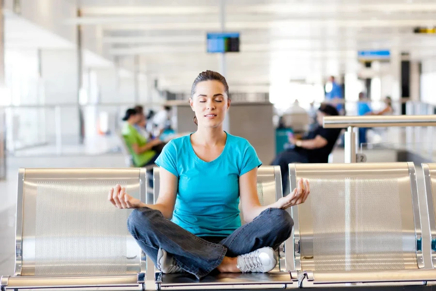 woman doing yoga meditation at airport