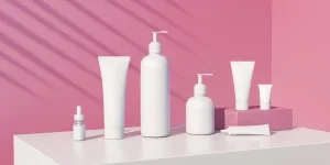 3d render of cosmetic bundle for skin hair care. White plastic package in row on bright millennial pink background. Sunny still life beauty branding set with fern shadows. Skincare products moc
