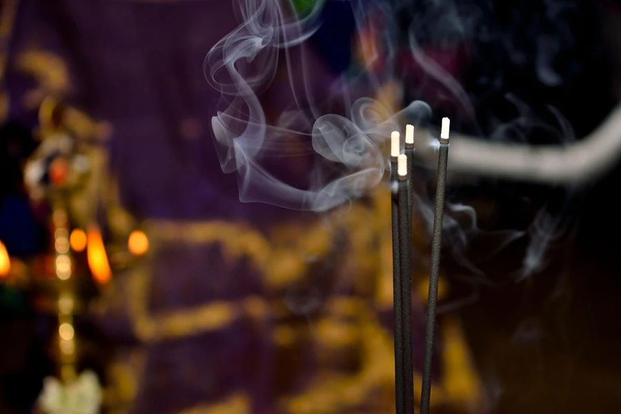 A Close up of a Burning Incense Stick Emitting Fragrant Smoke