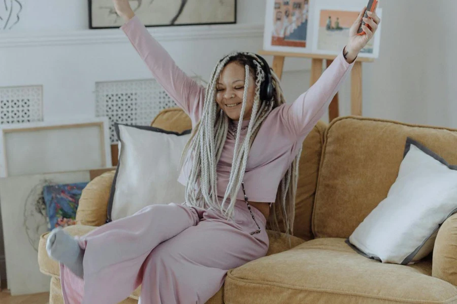 A Happy Woman Sitting on Sofa