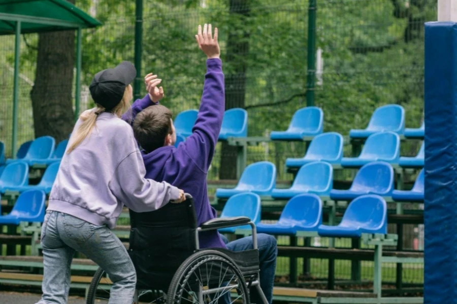 A Man Sitting on the Wheelchair Shooting a Ball