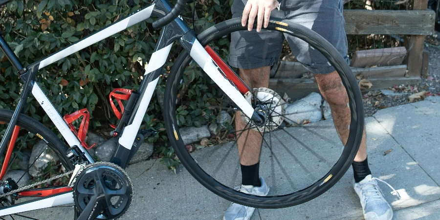 A Man in Black Long Sleeve Shirt Checking the Bike Tire by RDNE Stock project