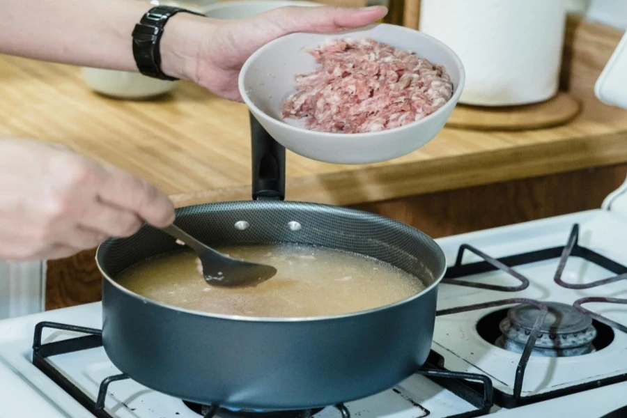 A Person Cooking a Soup Dish