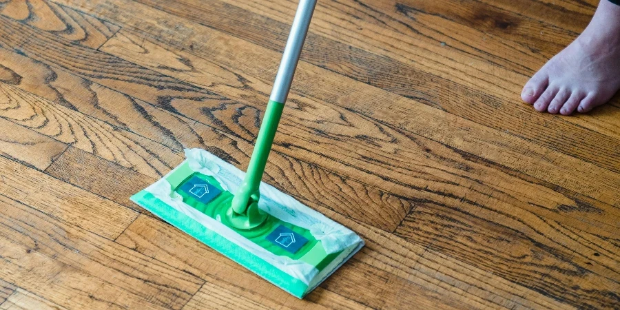 A Person Sweeping a Wooden Floor