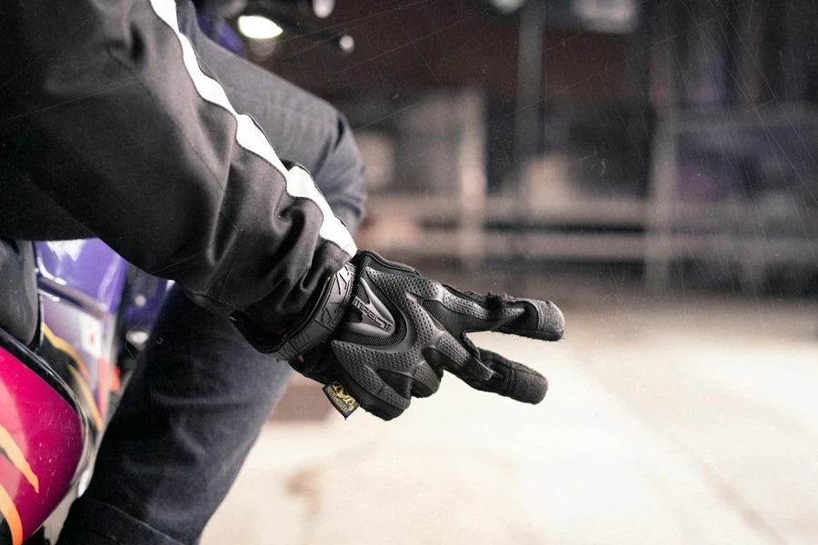 A Person in Black and White Jacket Wearing Black Gloves