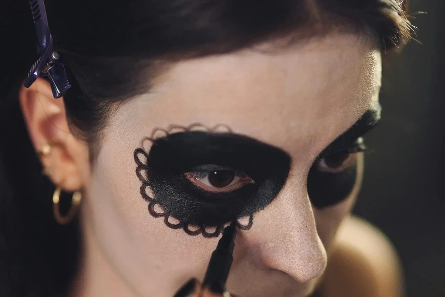 A Woman Putting a Catrina Makeup