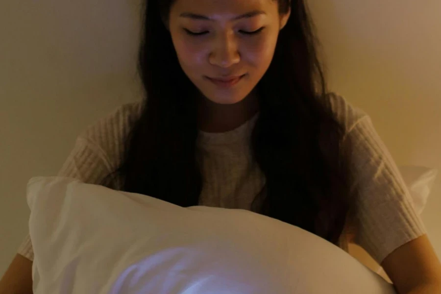 A Woman Smiling while Looking at her Smartphone