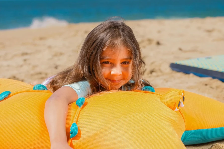 A Young Girl Lying on Inflatable Swim Ring on Beach