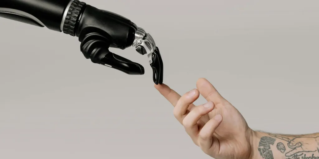 A bionic hand pointing at a human hand