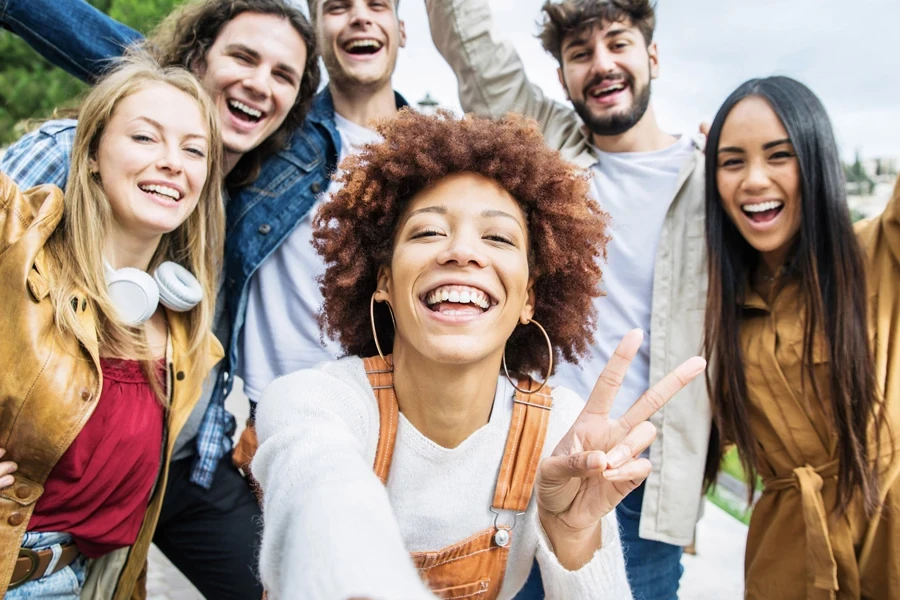 A bunch of smiling Gen Zers and Millennials