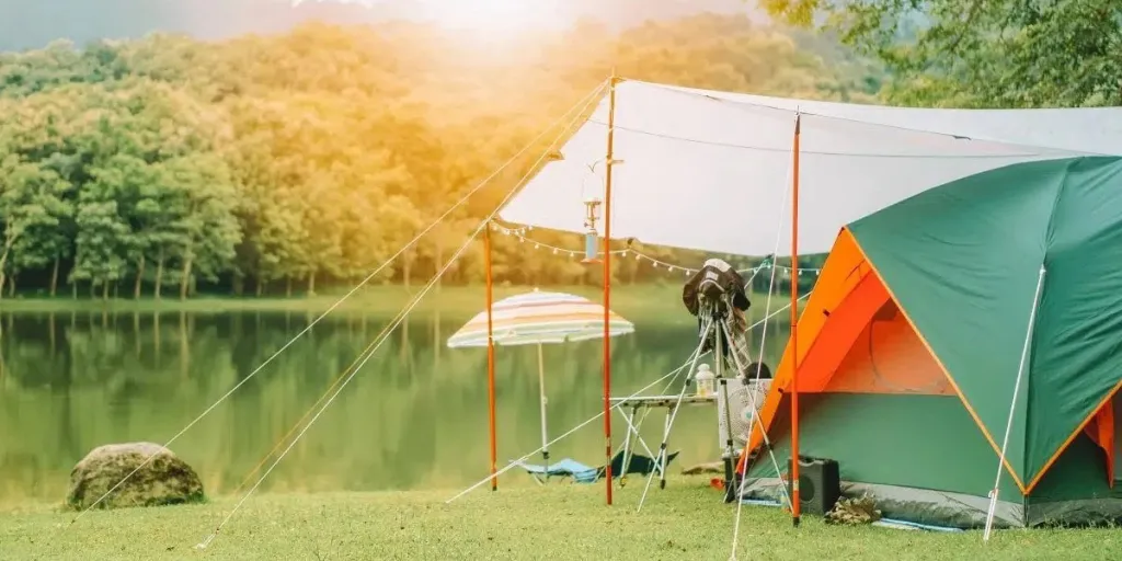 A camping site with a sun shelter and tent