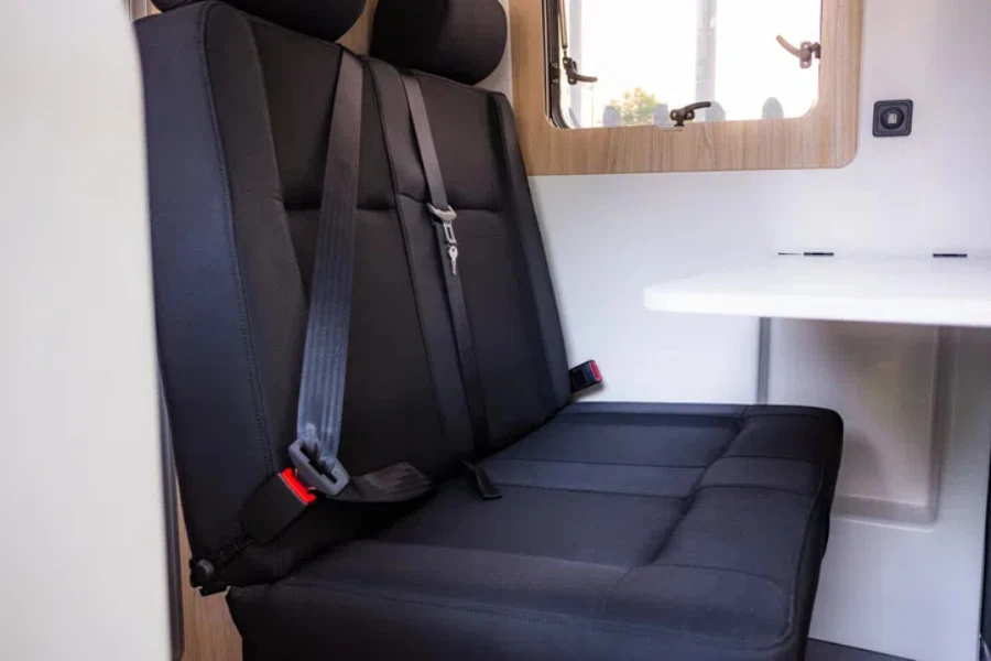 A closeup of the black clean seats inside a contemporary camping van