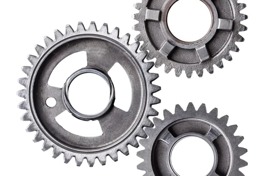 A cluster of interlocking metal gears isolated on a white background