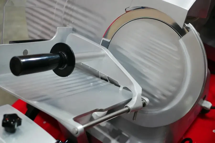 A commercial meat slicer, often found in delis and restaurants