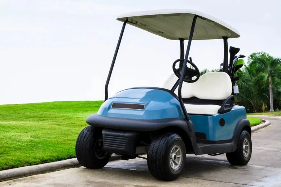 A golf cart with clubs on way to the Golf Course