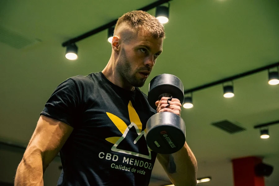 A man is lifting weights in a gym