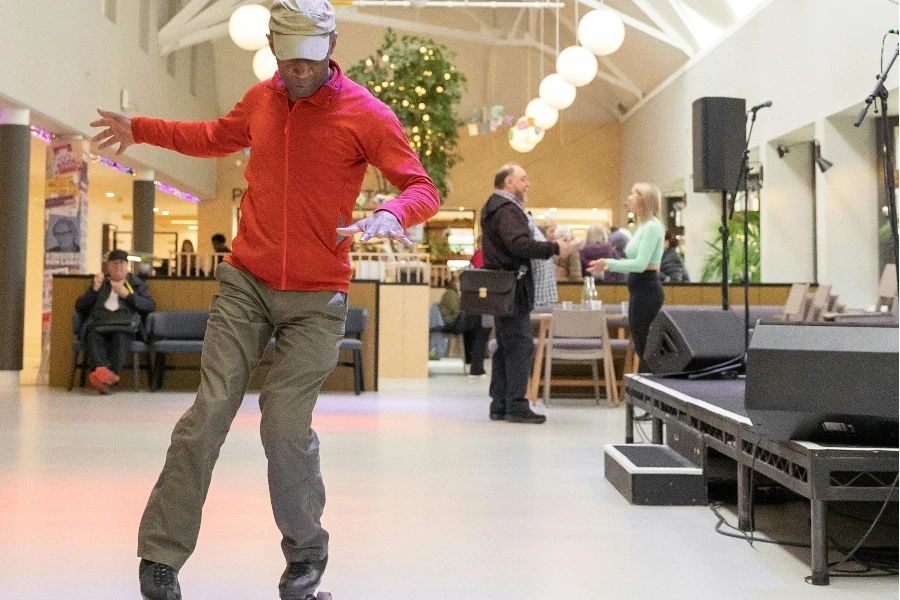 A man on roller skates in a large room