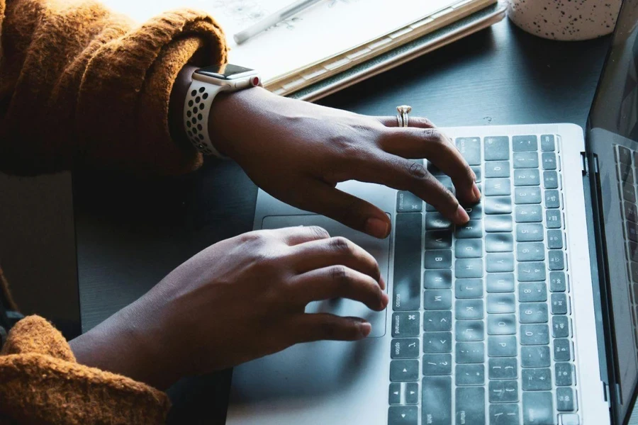 A person “Copywriting” on a silver laptop