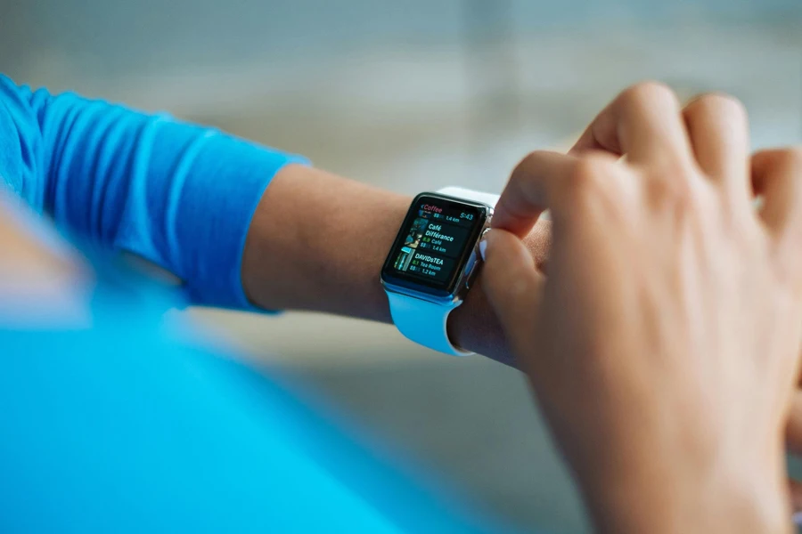 A person in blue using a smartwatch