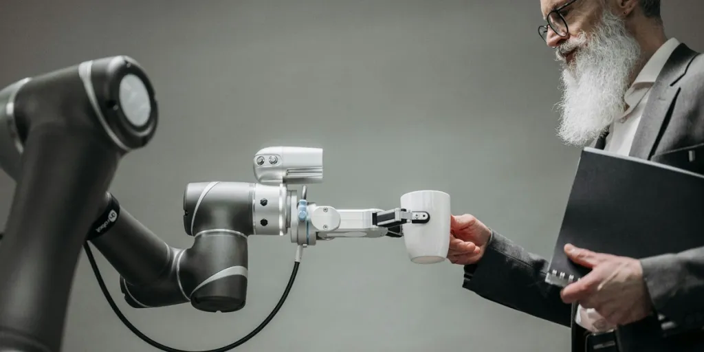 A person interacting with a robot holding a cup