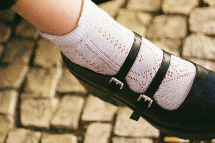 A sitting lady in black Mary Jane ballet flats