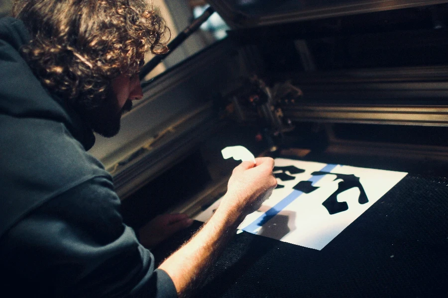 An engineer uses the laser cutting machine to test flat patterns