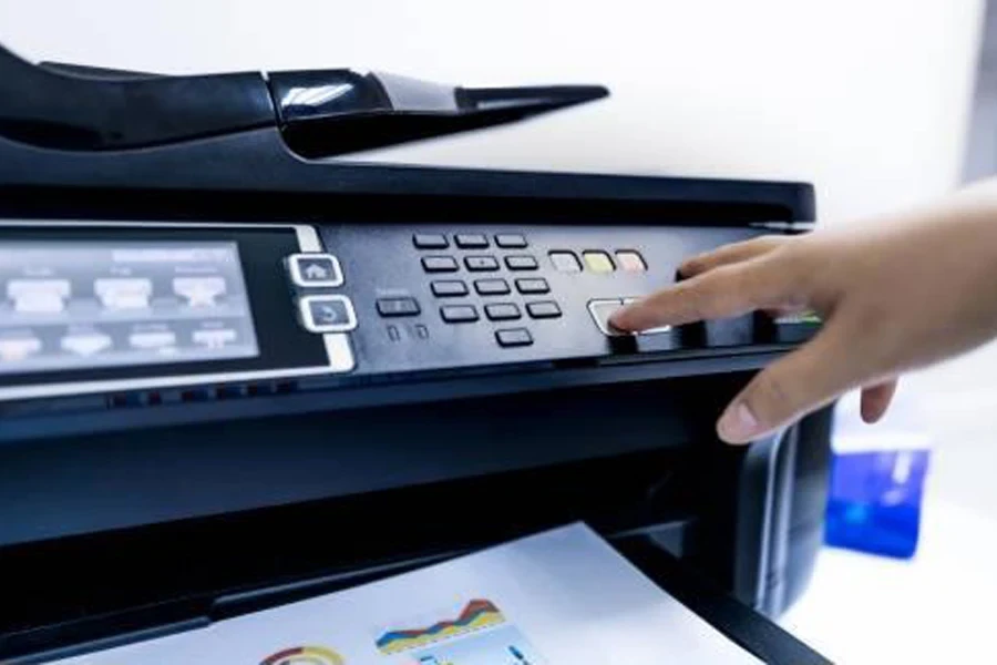 An office worker operating on a multifunction laser printer