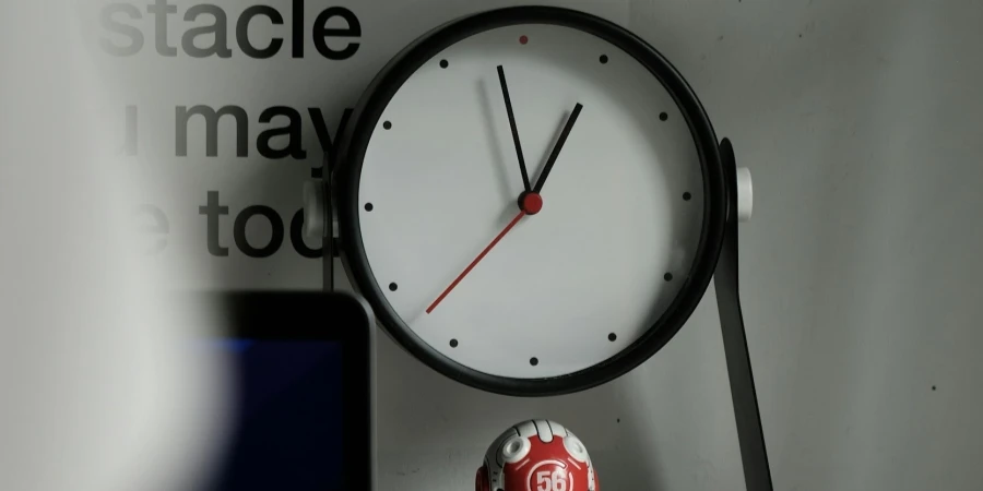 Analog Clock on White Desk by Febri Adiawarja