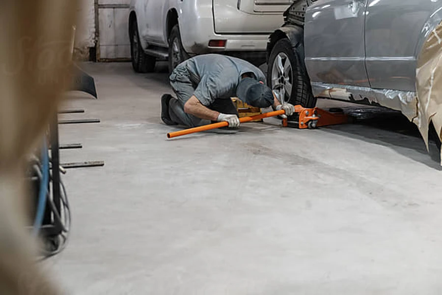 Anonymous mechanic lifting car in garage