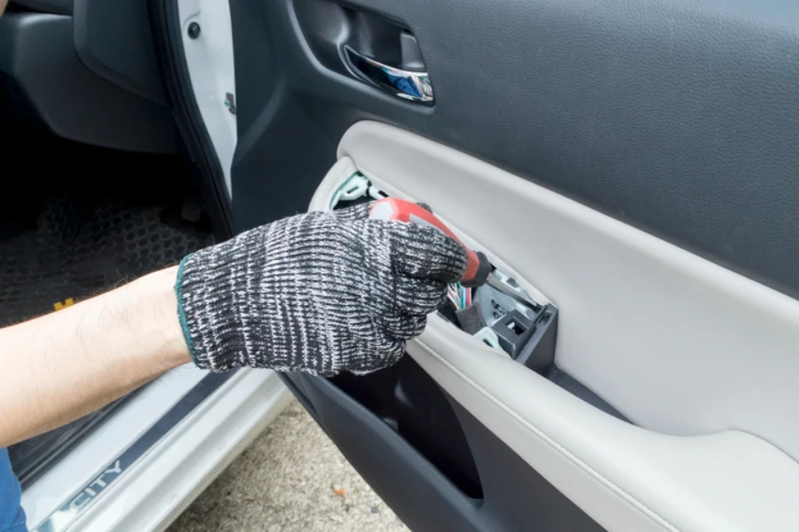 Auto mechanic remove car front door trim