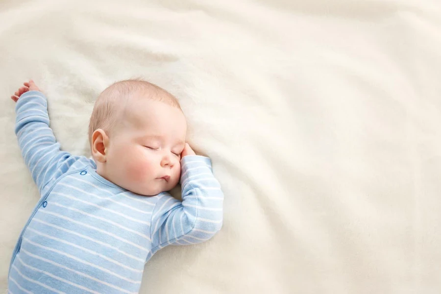 Baby sleeping covered with soft blanket 