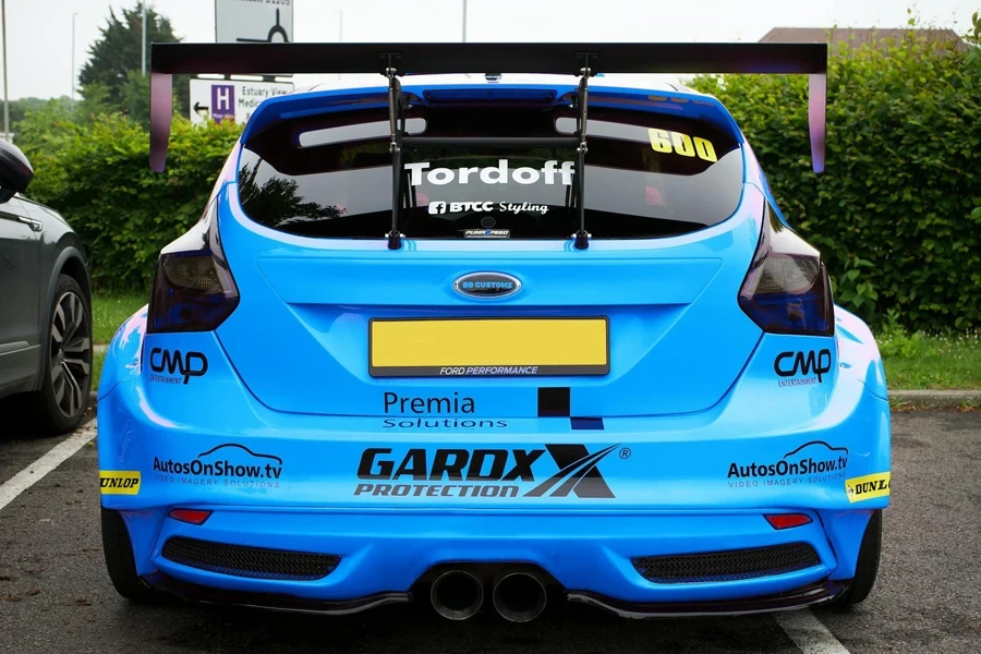 Back of a Blue Ford Focus RS with Stickers and a Spoiler