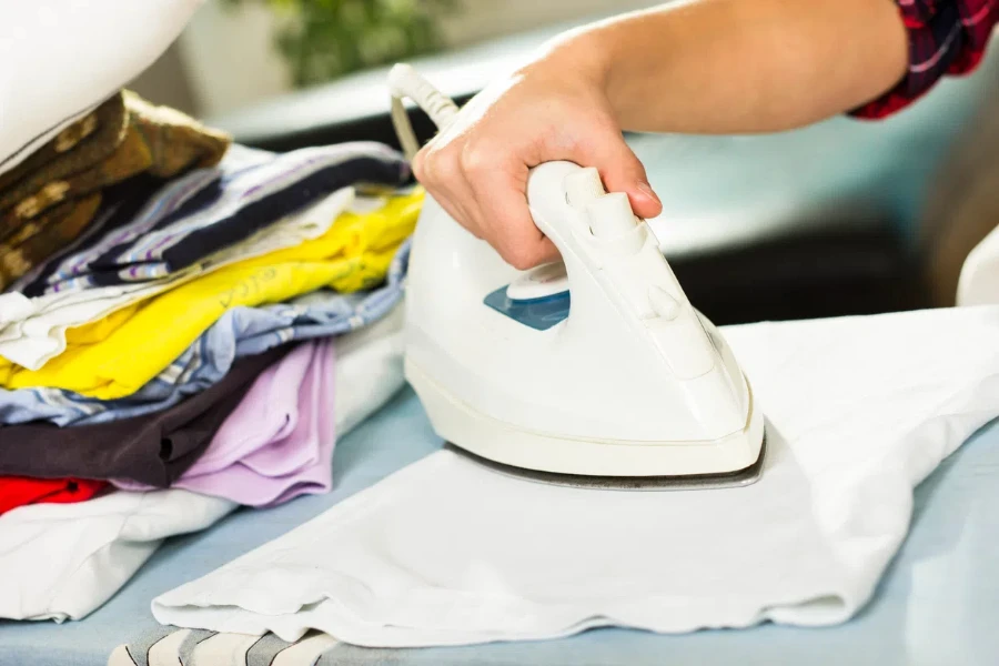 Beautiful woman ironing at home