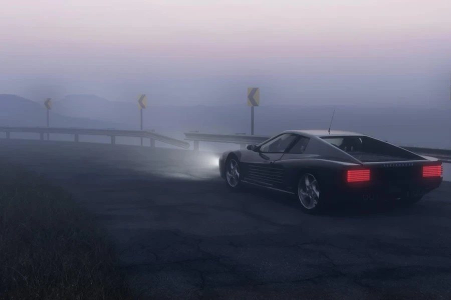 Black Coupe Parked on Concrete Road Near Body of Water