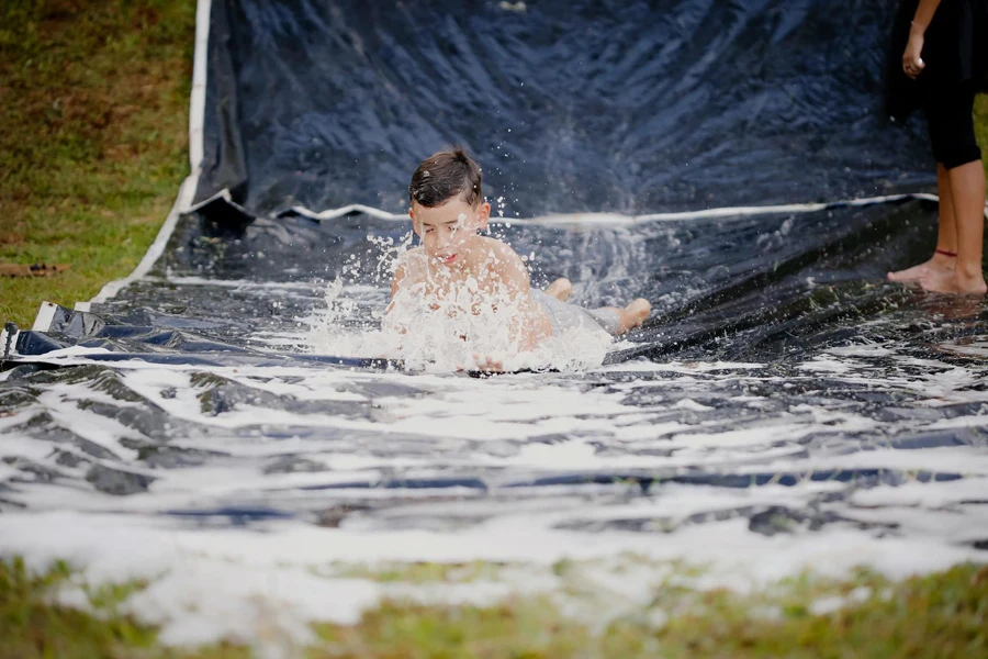 Boy Playing On A Slip And Slide