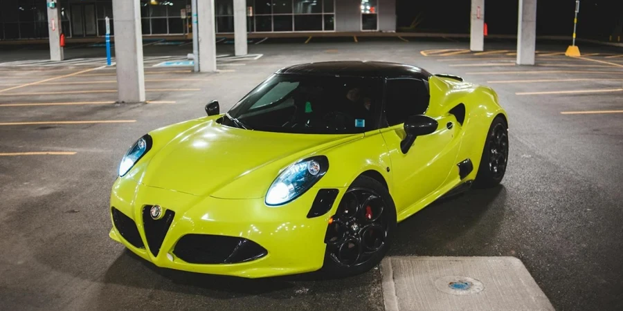 Bright yellow modern sports car with LED headlights parked on asphalt road on parking area