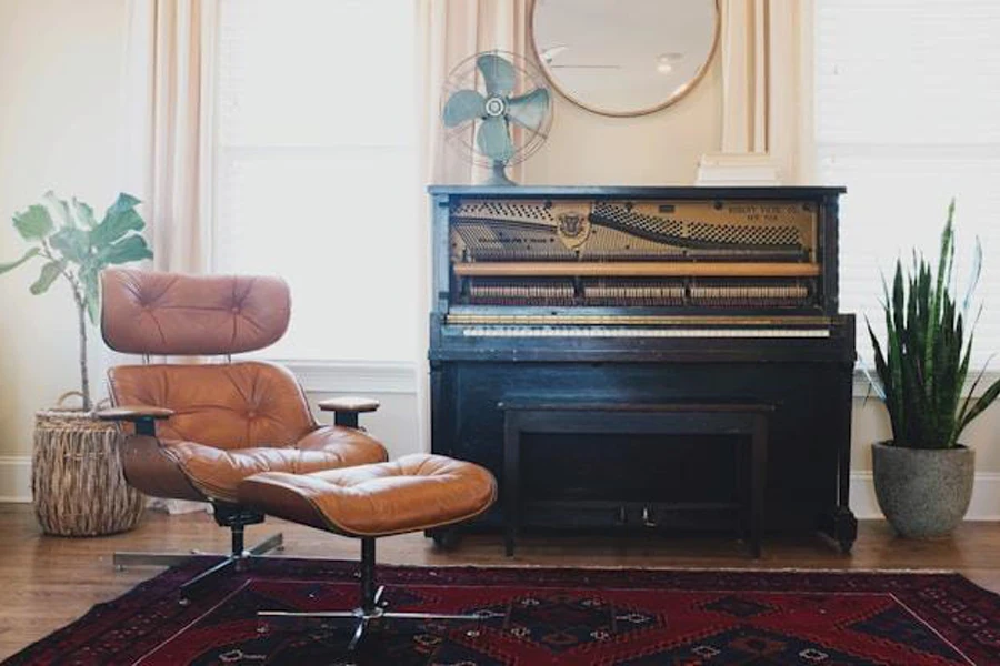 Brown leather reclining armchairs near a piano