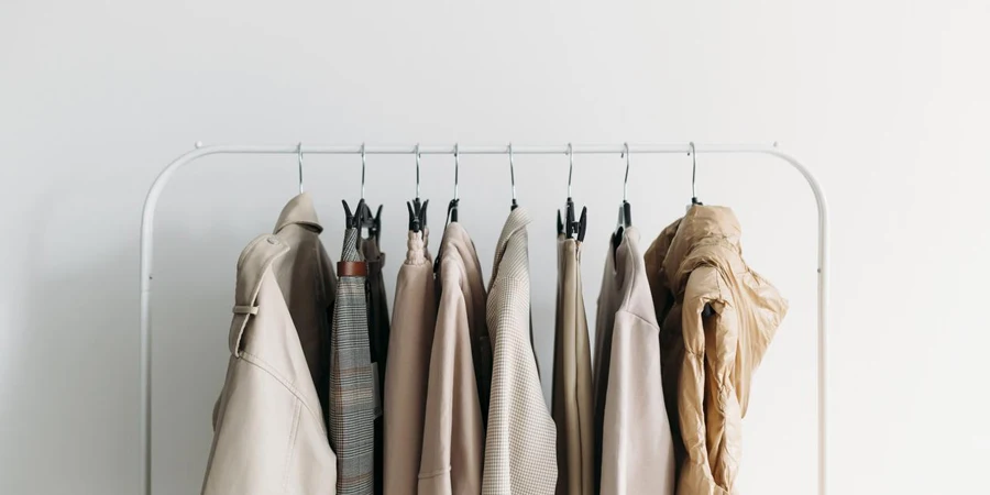 Capsule clothes of beige coloron a rack