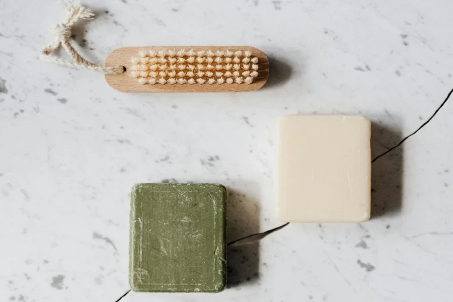 Cleaning brush and soaps on table with line chip