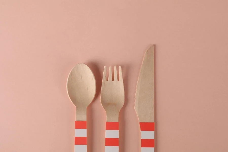 Close-Up Shot of Wooden Utensils on a Pink Surface