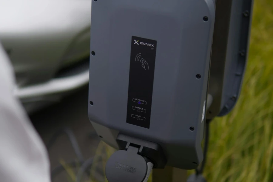 Close-Up View of a Person Holding the EV Charger