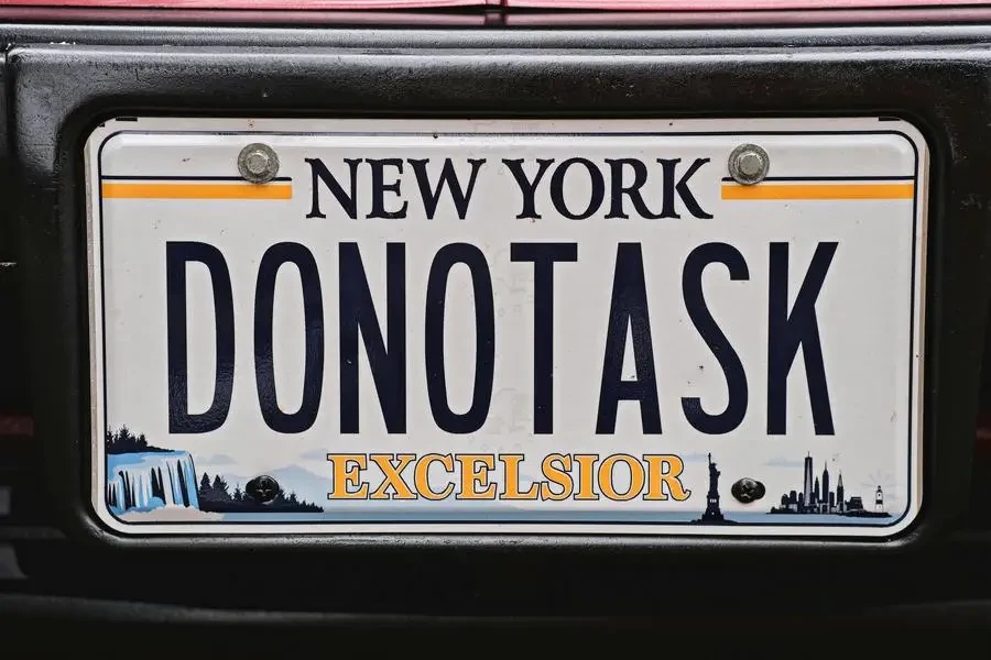 Close-up of a New York License Plate by Malcolm Garret