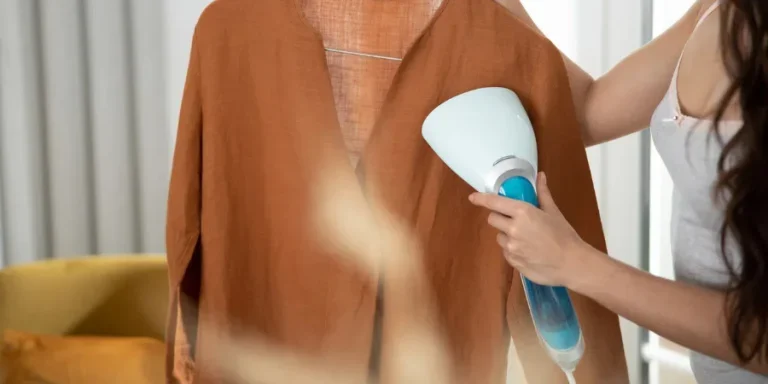 Close up of young woman lady steaming elegant blouse stock photo