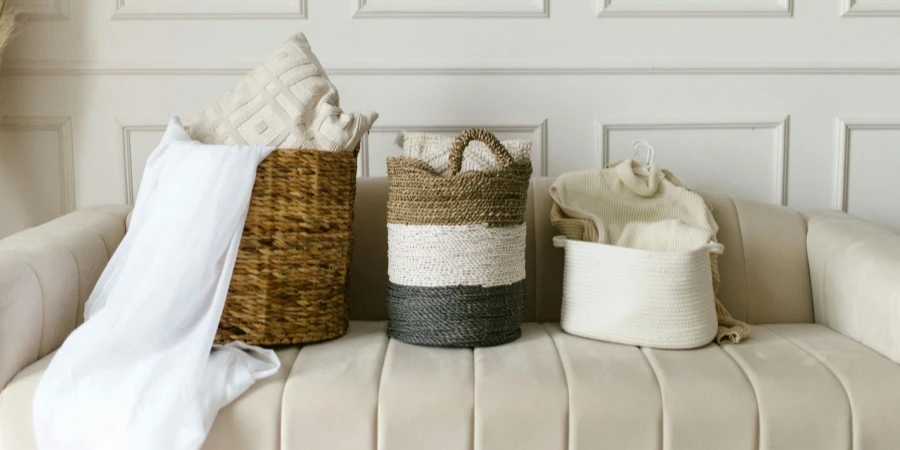 Clothing Items inside Woven Baskets on a Sofa