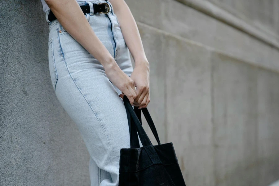 Crop Woman in Jeans and with Textile Bag in City