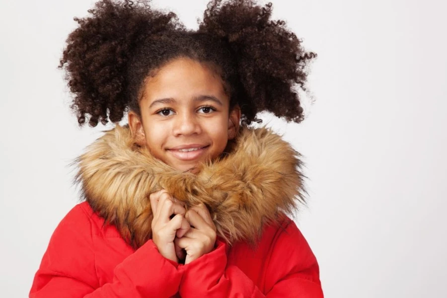 Cute teenager girl in red winter parka