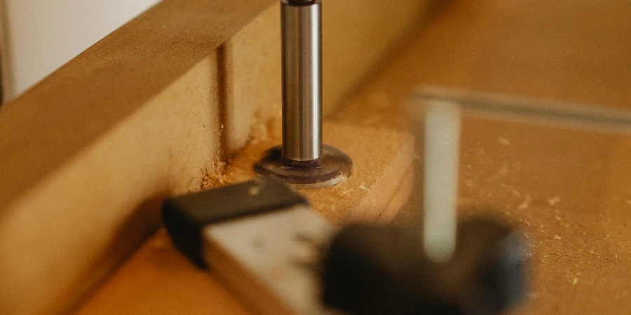 Drill press on wooden surface in workshop