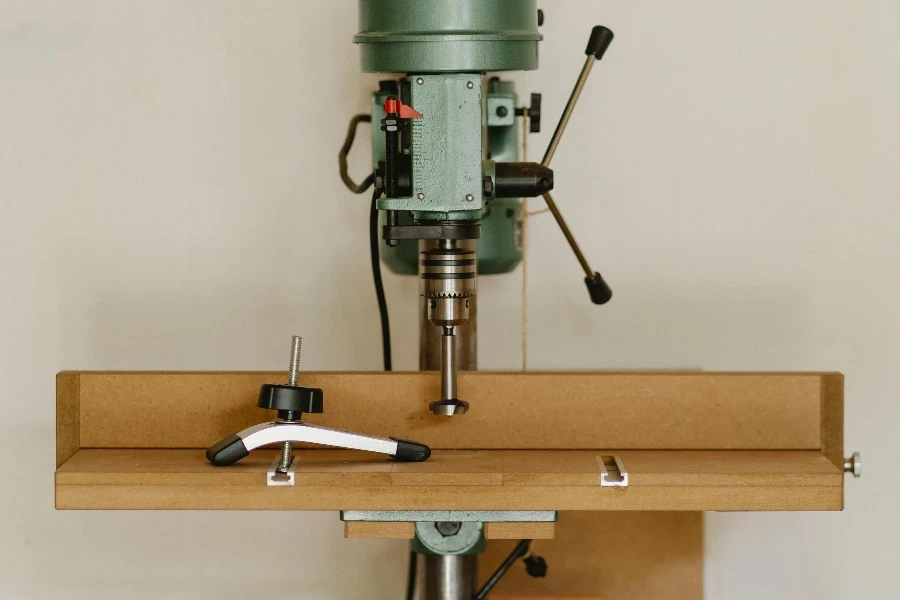 Drilling machine on wooden table